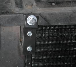 Slide condenser assembly down in front of the radiator.