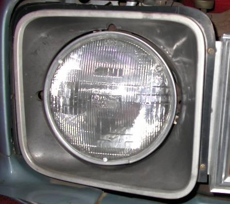 Remove and retain the 2 screws on driver side headlight