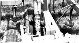 FIGURE 7. Depth Control Stops Used as Master Cylinder Transport Locks. Sweep to ground clearance during transport was 255 mm, while transport wheel tread was 2.6 m.
