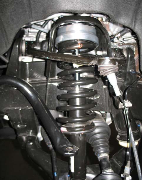 Make sure that the spring is seated correctly into the strut assembly and aligned with the previously