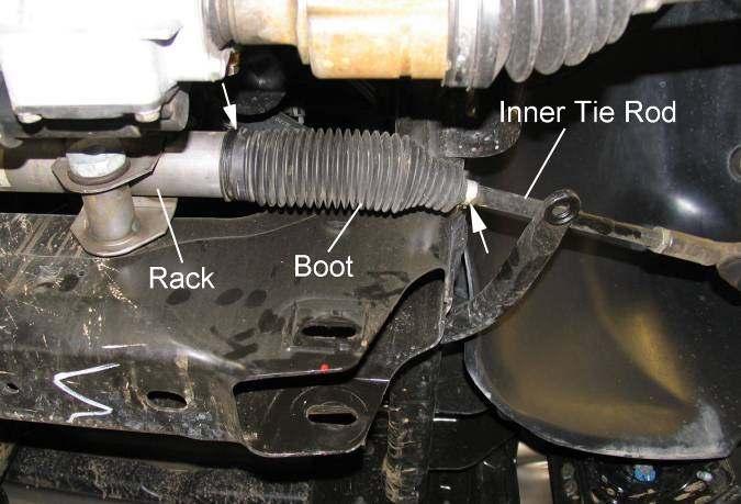 Lower jack and remove the coil-over assembly. Illustration 10 6) Remove lower control arm pivot bolts and lower control arm.