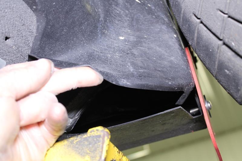 Push the mud flap in or pull it out to adjust the side exposure, level the mud flap and tighten