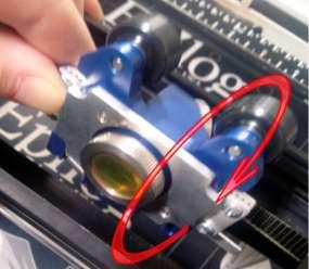Pull on one end of the belt to free it from the engraver. Do not discard the old belt at this time.