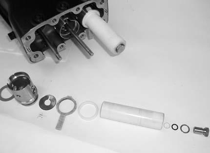Fit the packings together. Lightly lubricate the outside of the packings and insert, groove up, into the inlet manifold. Turn the crankshaft.