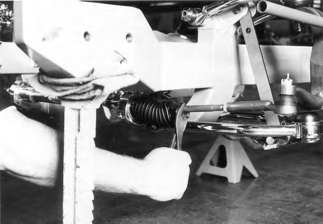 Use vise-grips to grab onto the tie rod and rotate it to adjust the length. Be careful to turn both tie rods the same amount.