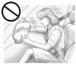 74 Seats and Restraints { Warning Never hold an infant or a child while riding in a vehicle.