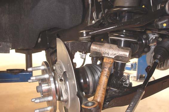 10. Remove the upper ball joint using a 18mm socket and