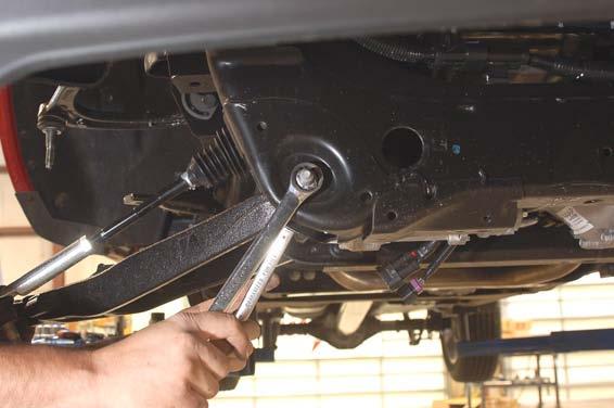 16. Remove the lower control arm using a 18mm wrench and a 24mm socket.