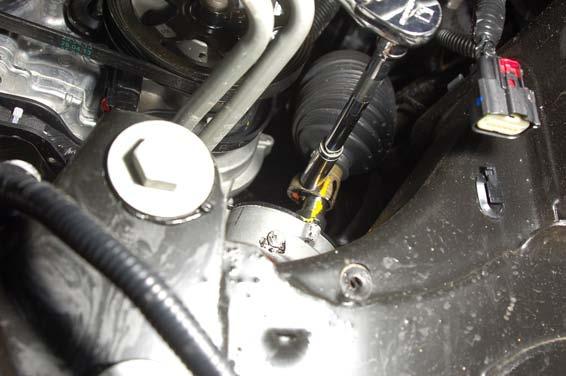 Using a 11mm socket, remove the bolt in the intermediate shaft. See Photo 14.