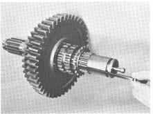 To Disassemble the Mainshaft Assembly 11. Remove the 1st and 2nd speed gears with washers and spacers from mainshaft (See Illustration #37). 12. Remove the quill bearing snap ring. 13.