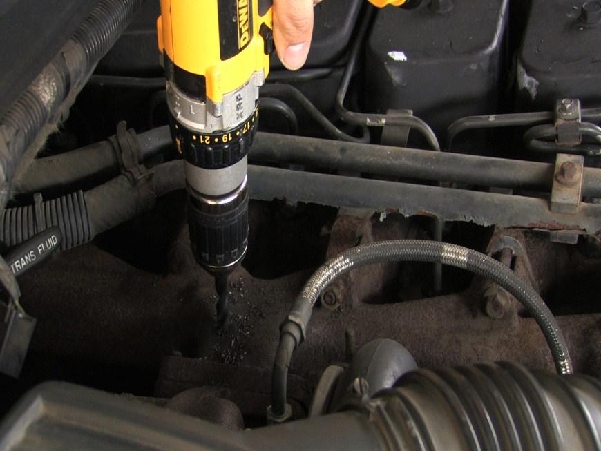 Drill the exhaust manifold on the mark you made using a size R drill bit.