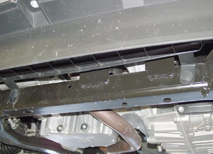 On both sides, remove two 7mm (head) bolts attaching the fascia to the fender and the