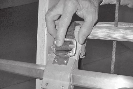 4.2 With buckle hooks facing away from ladder, wrap clamp assembly straps around ladder