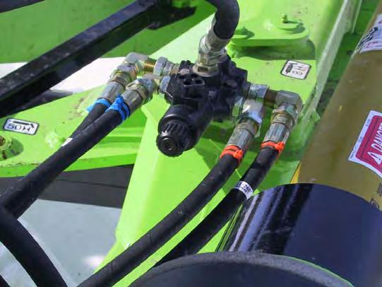 Connect the rotary cutter hoses to the breakaway stand on the flex arm. The hoses are wrapped with color coding and/or ties for ease of assembly.