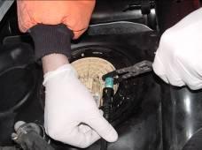 Remove the original fuel suction line Quick Connect fitting from fuel tank by squeezing the tabs on the end of the connector together.