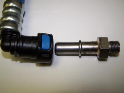 Insert the tool into the connection and turn it ¼ turn to open the retaining spring.