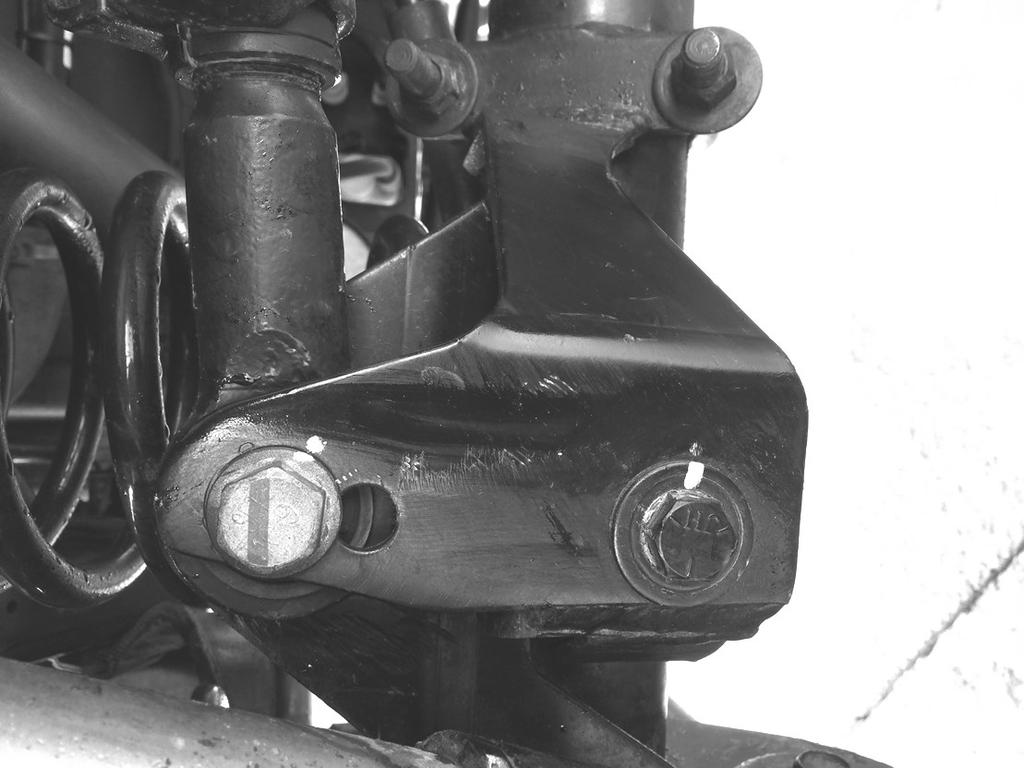 7 Example of trimmed TeraFlex track bar bracket. Before installing the springs, cycle the suspension. Check for shock clearance around the axle side track bar bracket.