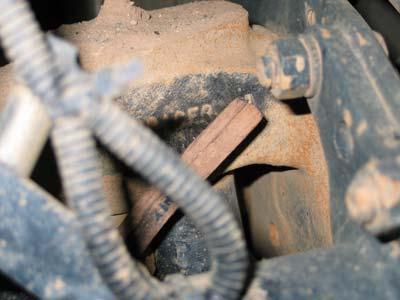 Locate the forging part number that is forged into the front, top of the steer knuckle.
