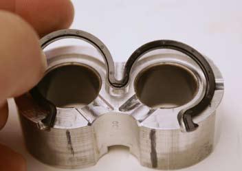 Note that the tab in the center portion of the back-up ring is flush to one surface.