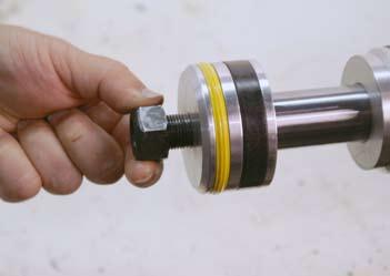 3. Slide the piston onto the cylinder ram (Fig. 0555). 5.