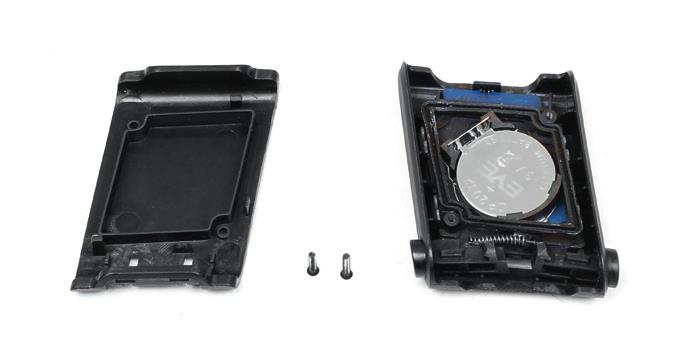 Carefully remove the battery by offsetting the marked battery holder pin (Figures 6 and 7).