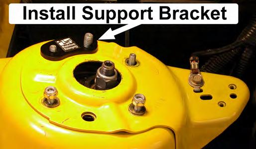 Place the passenger-side Support Bracket onto the protruding studs, as shown in the photo.