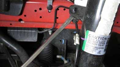STEP 2 Remove the sway bar end link from the strut, then loosen but do not remove the