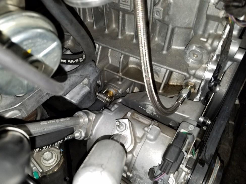 30) Slide the hose clamp over the coolant hose end and then slide the coolant hose onto the hose barb on the block. Secure it in place by sliding the hose clamp into position and tighten.