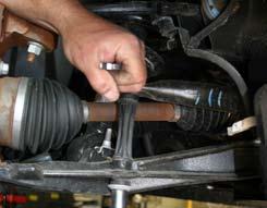 Remove the tie rod end from the knuckle by using a tie rod puller. (See Photo # 2) Photo #1 4.