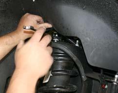 (See Photo # 3) Simply wire the brake caliper out of the way.