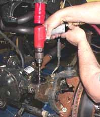 Remove the sway bar end links & brake calipers from the OEM mounts. (See Photo # 1) 6. Lower the front differential & remove the front coil springs. 7.