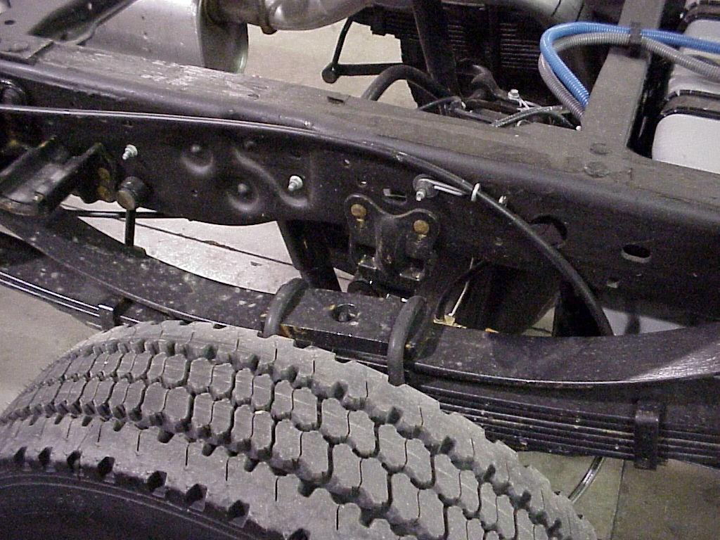 Remove and discard OE U-bolts, Washers, and Nuts. See Figure 3-2. 3. Remove the front spring hanger bracket and front overload spring bracket.