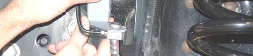 Position the coil springs in the lower coil buckets on the axle and rotate as necessary to be sure that the pigtail