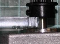 Insert the motor plate between the pulley and cylindrical motor boss and slide the pulley down to meet the plate (as shown in Figure 13). 15.