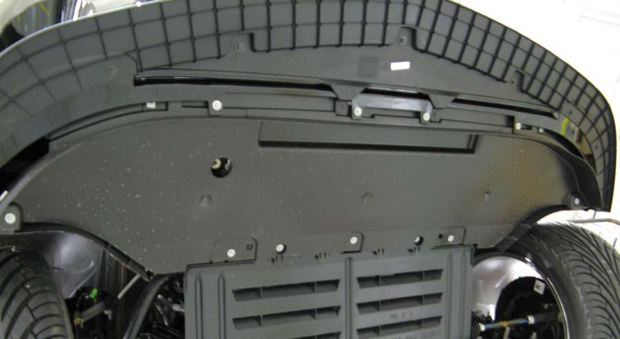 5 mm socket, remove nine (9) screws from the lower close-out panel; one (1) at each wheel well splash shield, four (4) at the front fascia and three (3) at the rear edge of the close-out panel.