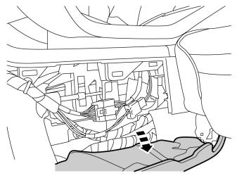 Fold aside the floor mat on the left side of the center console.