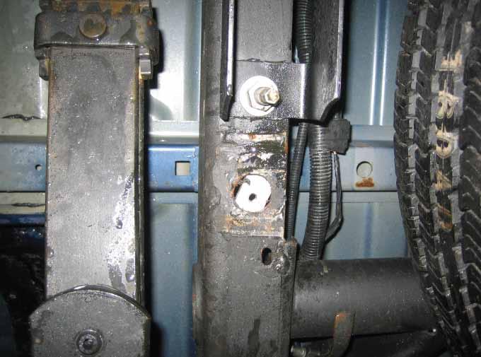 rectangular-shaped mounting plate on top of the frame rail over the hole