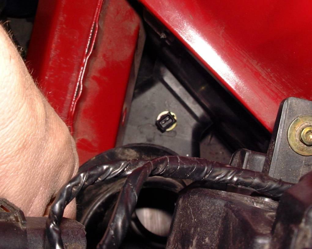 Standing in front of the car, looking straight down where the stock air box was, locate the top of the brake duct.