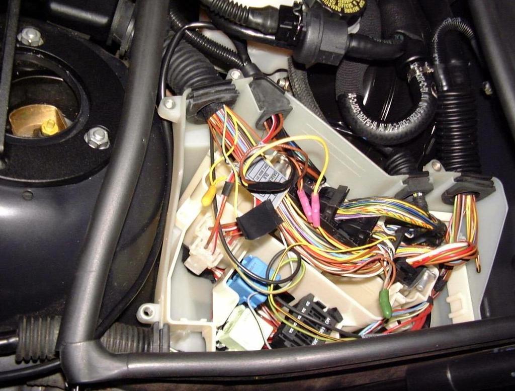 11. Run the Sensor Harness up along the underside of the existing wire harness towards the ECU compartment. 12. Remove the top of the ECU compartment. 13.