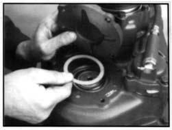 9 After the correct shim has been selected, place the shim on the rear countershaft bearing race, install the countershaft rear bearing gasket and cover.