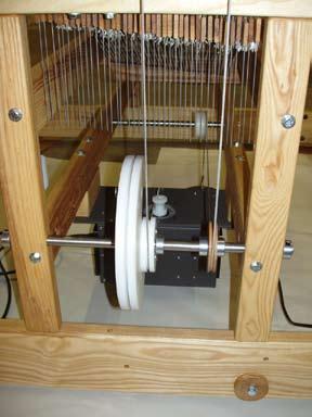 2) Use the wood Mounting Blocks, four 5/16 x 6 hex bolts, washers, and hex nuts to mount the E-Lift II to the underside of the Treadle Pulley Support Crossmembers.
