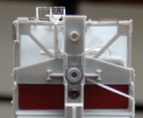 21. Install the screws to attach the underframe to the hopper body. Open the bag of screws. You will find three pairs of screws; one long, one short, and one in between.
