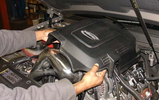 Once you have cleared the cast intake from the fan blades and radiator hose, continue to tighten the power-band on the