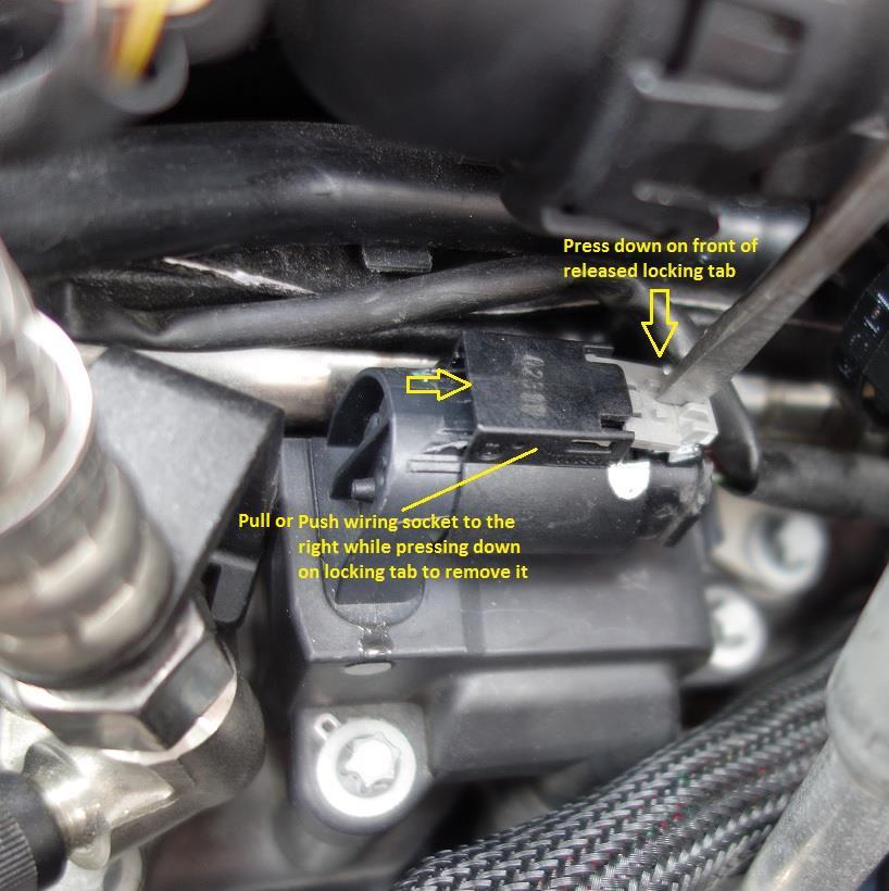 c. Remove the wiring socket from the ignition coil by pulling the socket away from the coil while