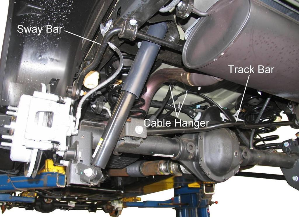 Rear Suspension REAR SUSPENSION SHOCK ABSORBER & COIL SPRING REMOVAL 1) Chock front wheels. Raise the rear of the vehicle and support the frame with jack stands. Remove the rear wheels.