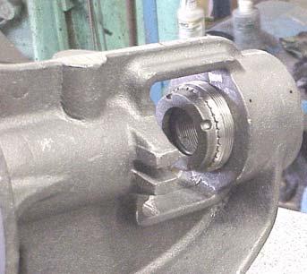 Using the idler and bushing assembly as a guide, press the idler pin into the head with the tapped hole into the head and the lubrication hole or groove directed toward the center of the crescent on