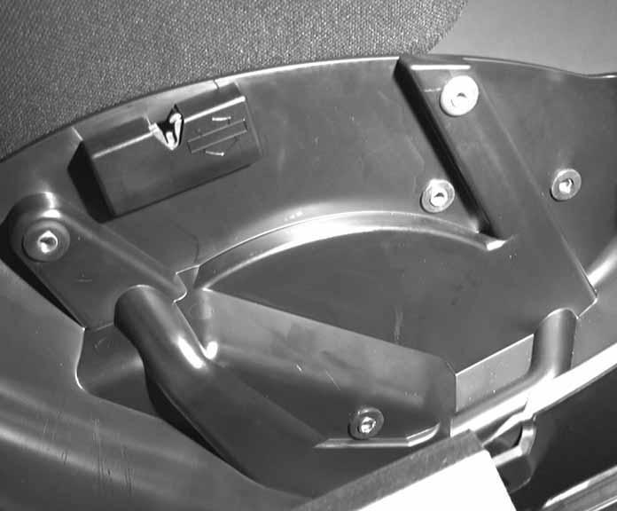 Starting at () in Figure, place a washer (Part Number 65) on screw (Part Number 88). Partially insert screw from inside the saddlebag. Locate a second washer (part number 65) from the hardware kit.