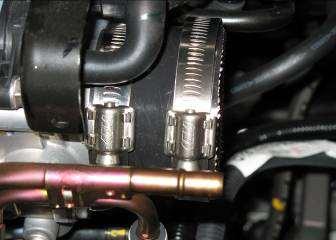 Slide the short upper intake pipe into the throttle body with