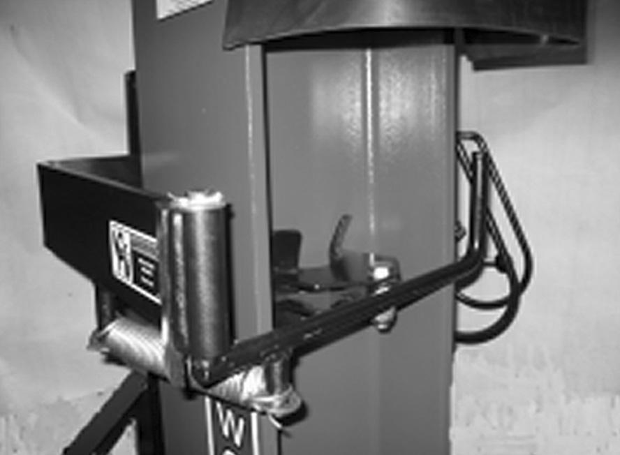 Using the vertical handle on the arm weldment, swing the Post Holder away from the ram and to the left. The arm will go over center and remain to the left side of the post driver. FIG.