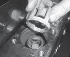 2) Using either a pin spanner or pliers, take out complete discharge valve (52),